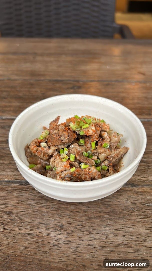 Bowl of seasoned meat with green onions