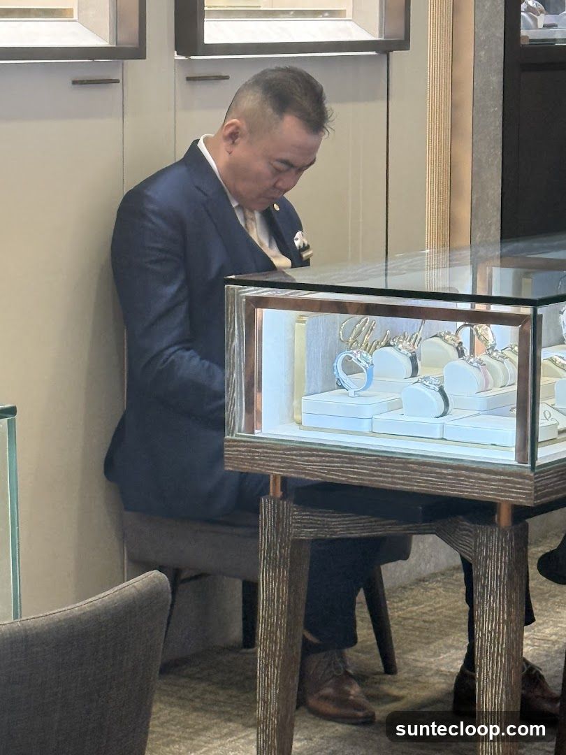 Man in Suit Looking at Display Case