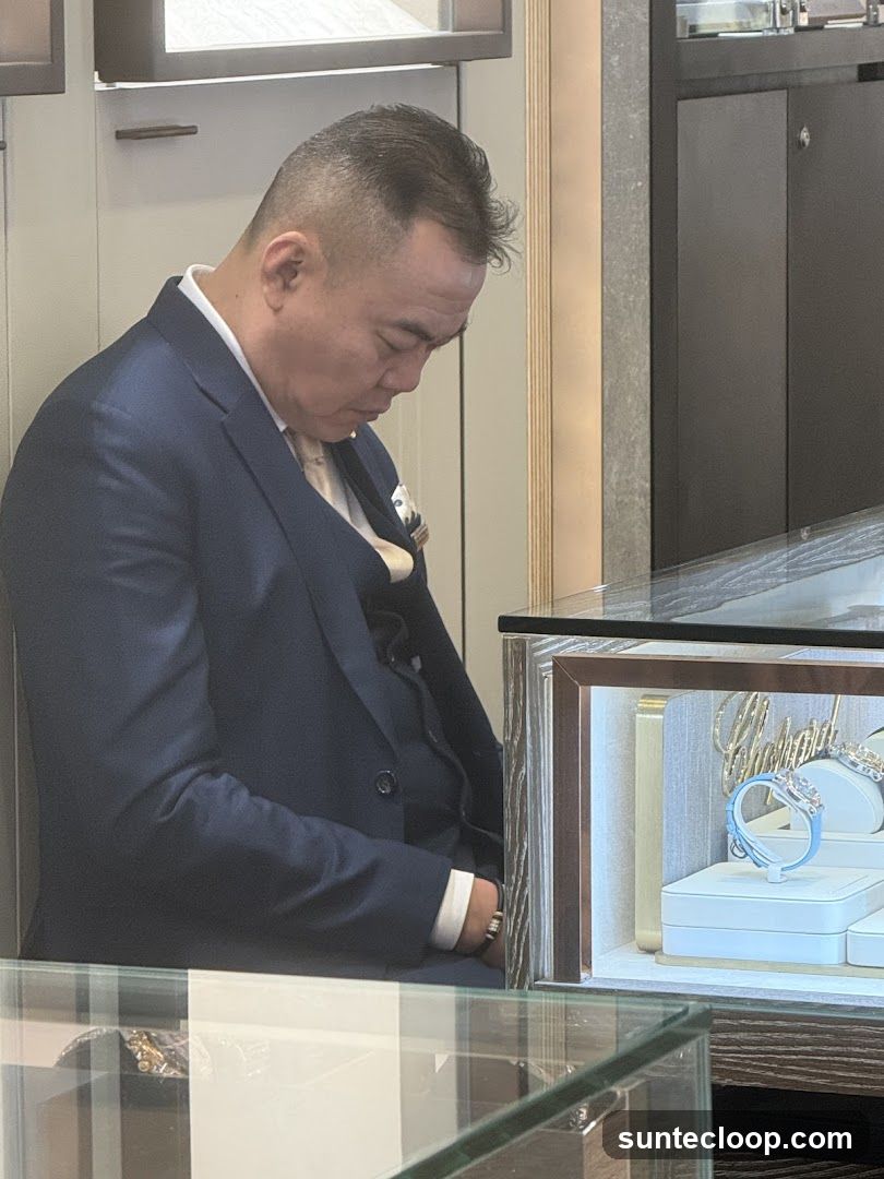 Man in Suit Looking at Jewelry Display