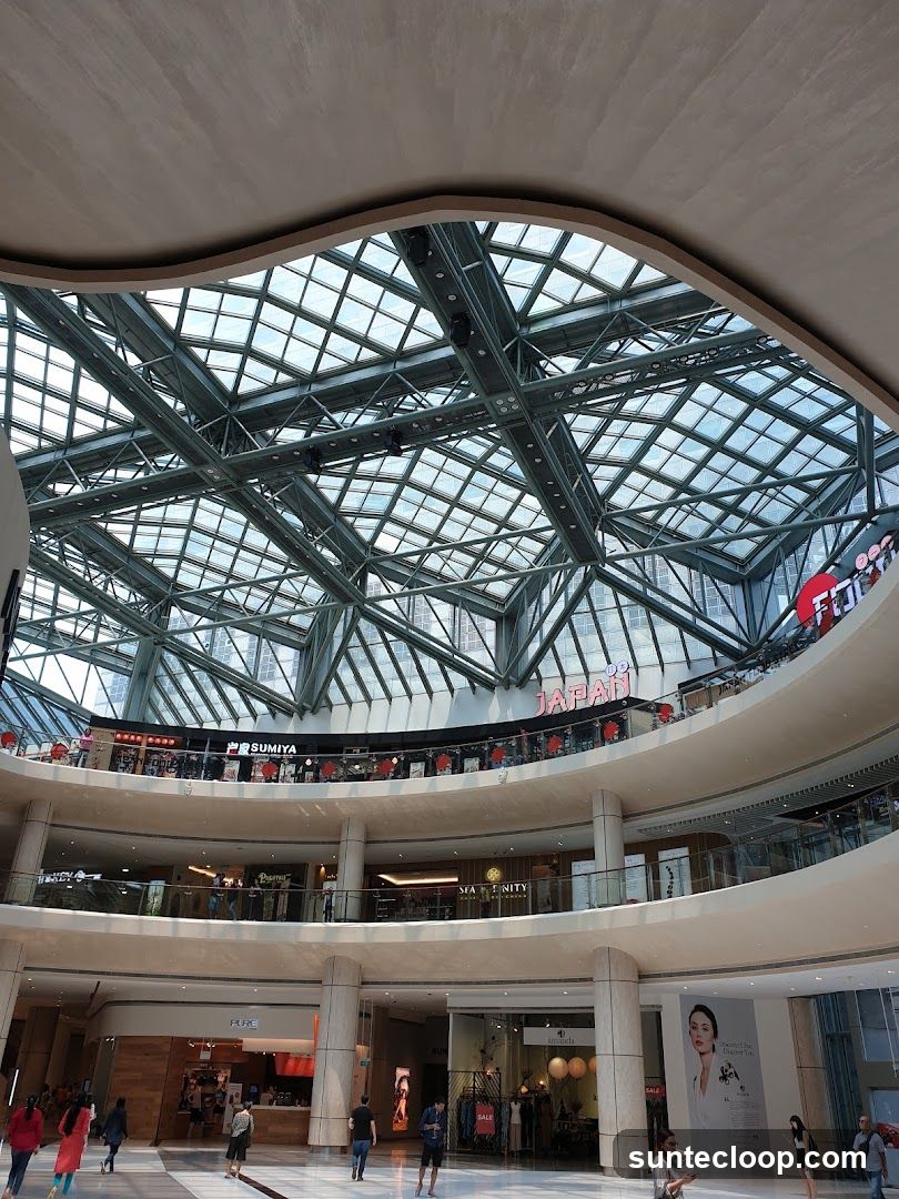 Interior of a modern shopping mall with a large glass ceiling