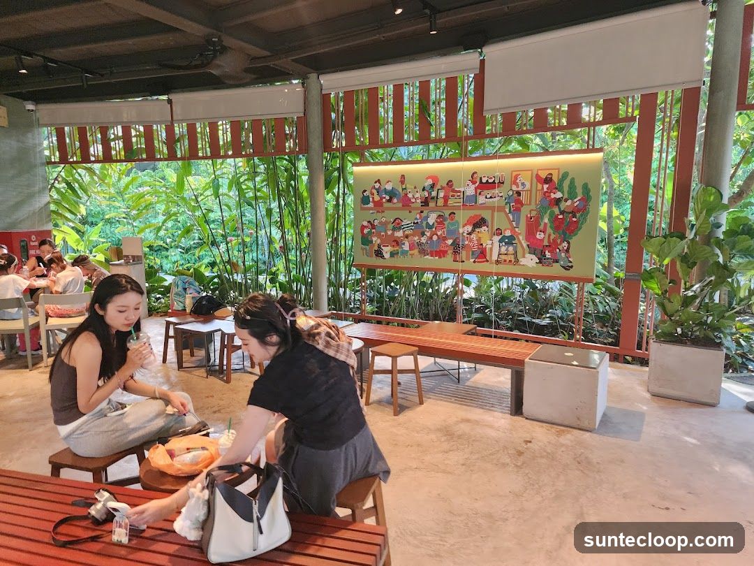 People enjoying drinks in a cafe with lush greenery