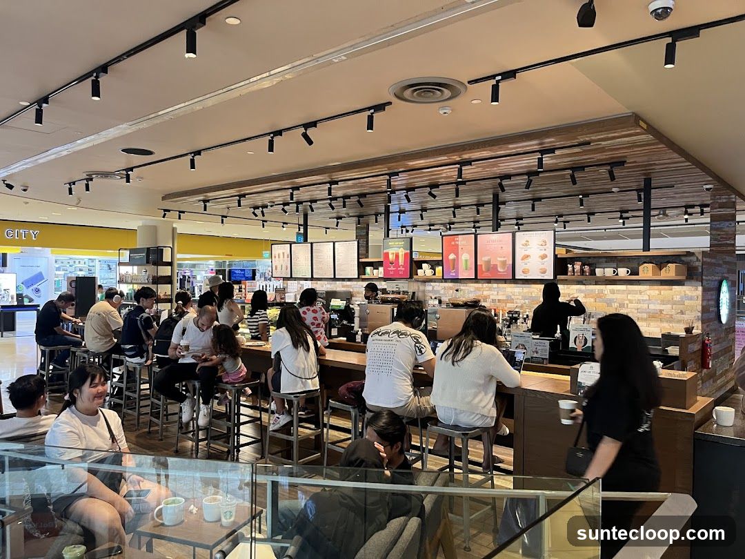 Busy cafe interior with customers at the counter and tables