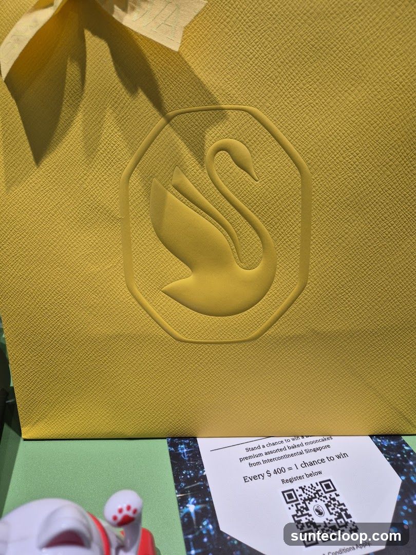 Yellow Gift Bag with Swan Logo and Promotion