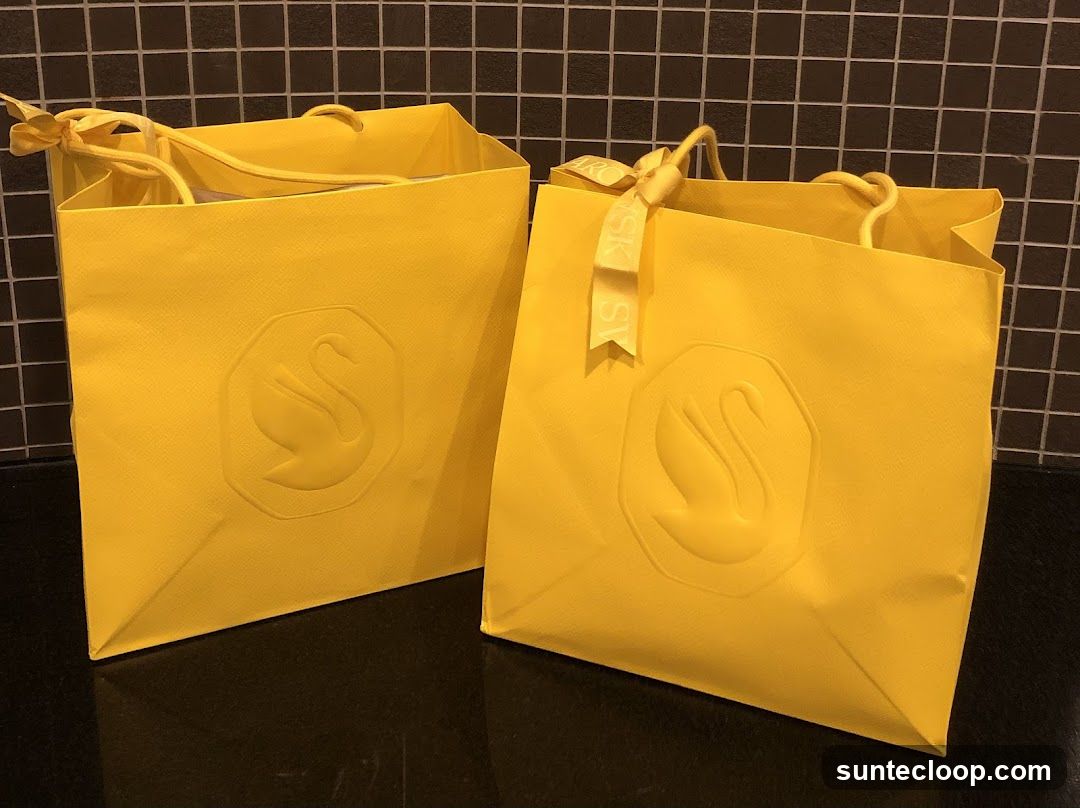 Yellow Shopping Bags with Swan Logo