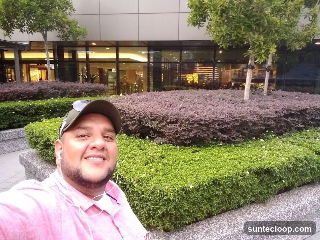 Man in front of a building with landscaping