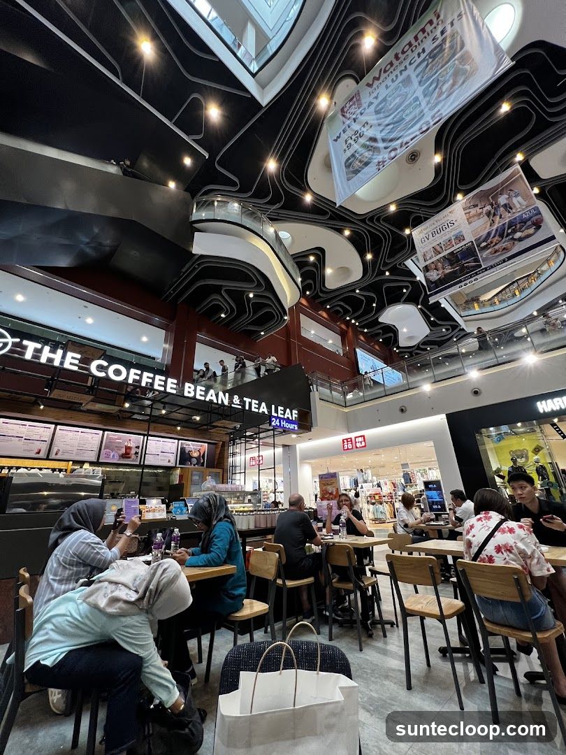 Interior of a mall with a coffee shop and other stores