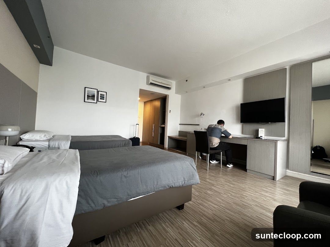 Hotel Room with Two Beds and a Desk