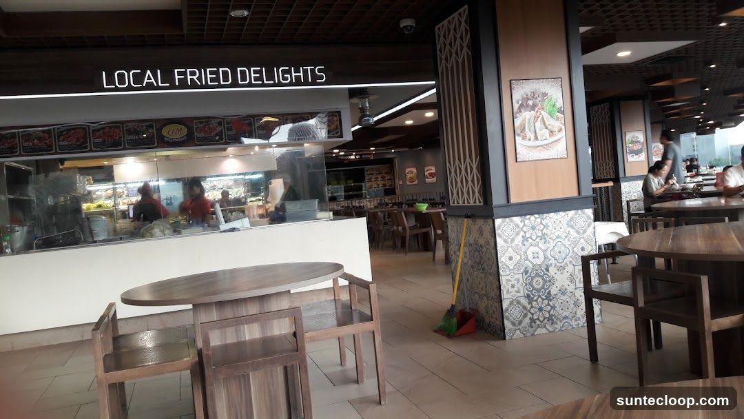 Food court interior with seating and food stalls