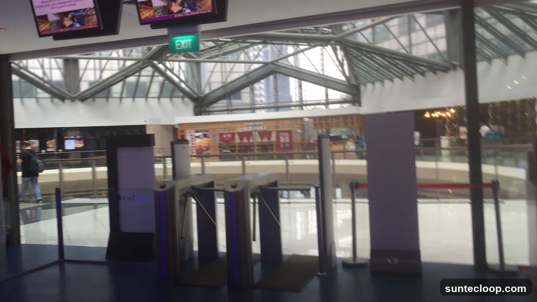 Interior of a Mall with Turnstiles and Food Stalls