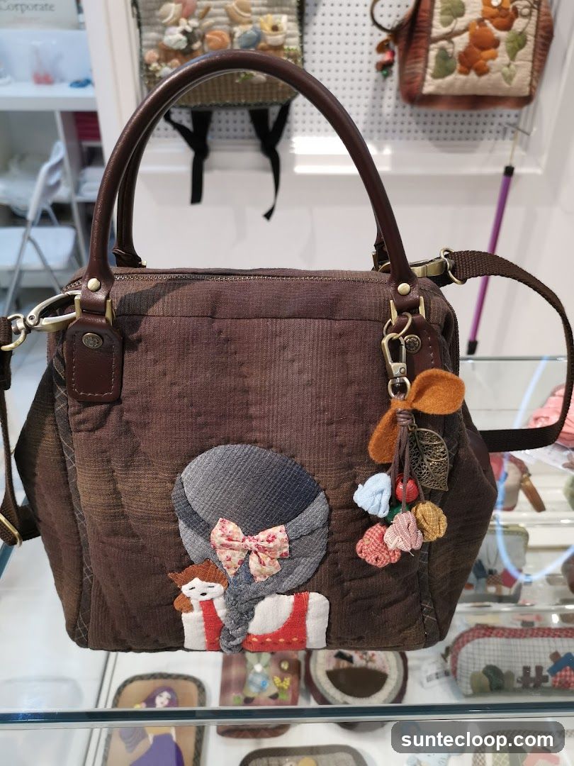 Brown handbag with applique
