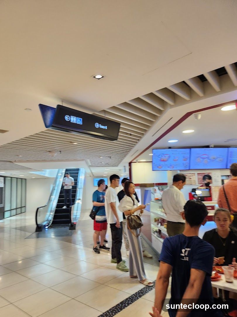 People queuing at a food counter