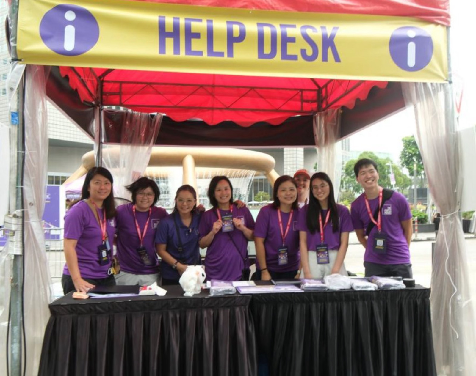 Purple Parade 2026 help desk with earplugs, ponchos and maps at Suntec City